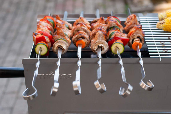 Meat and vegetable skewers on a grill