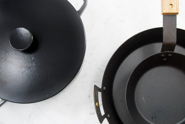 Black pots and pans with wood handles