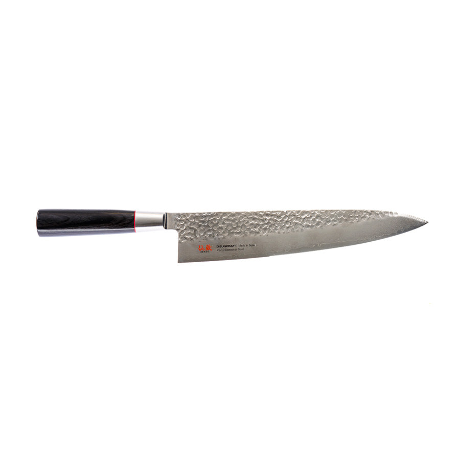 A Japanese gyuto knife with a damascus-patterned blade and a dark handle, shown on a plain ground.